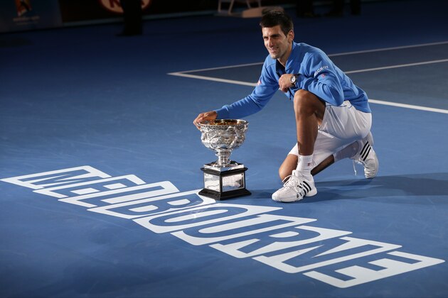 Novak Djokovic of Serbia poses with the trophy after defeating Andy Murray of Britain in the men's singles final at the Australian Open tennis championship in Melbourne, Australia, Sunday, Feb. 1, 2015. (AP Photo/Vincent Thian)