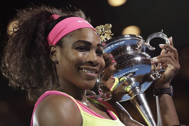 Serena Williams of the U.S. holds the trophy after defeating Maria Sharapova of Russia in the women's singles final at the Australian Open tennis championship in Melbourne, Australia, Saturday, Jan. 31, 2015. (AP Photo/Bernat Armangue)