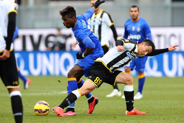 Juventus' Paul Pogba, left, and Udinese's Ivan Piris vie for the ball during the Serie A soccer match between Udinese and Juventus at the Friuli Stadium in Udine, Italy, Sunday, Feb. 1, 2015. (AP Photo/Paolo Giovannini)