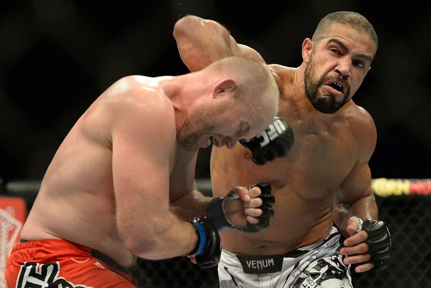 Jan 31, 2015; Las Vegas, NV, USA;  Tim Boetsch (blue gloves) takes a punch from Thales Leites (red gloves) during their middleweight bout during UFC 183 at the MGM Grand Garden Arena. Mandatory Credit: Jayne Kamin-Oncea-USA TODAY Sports