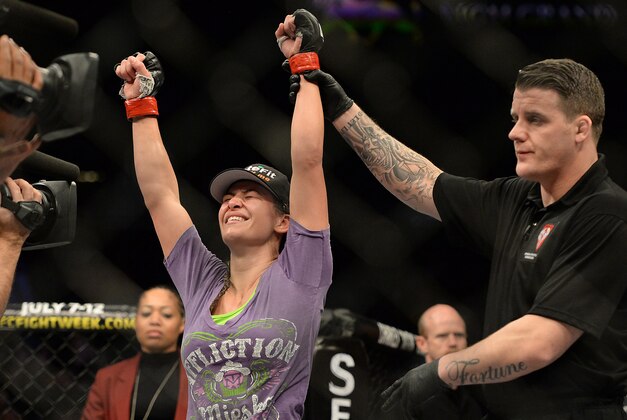 Jan 31, 2015; Las Vegas, NV, USA;  Referee Marc Goddard announces Miesha Tate (red gloves) victorious over Sara McMann (blue gloves) following their women's bantamweight bout during UFC 183 at the MGM Grand Garden Arena. Mandatory Credit: Jayne Kamin-Oncea-USA TODAY Sports