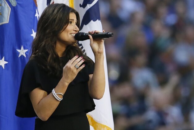 Idina Menzel sings the national anthem before the NFL Super Bowl XLIX football game between the Seattle Seahawks and the New England Patriots Sunday, Feb. 1, 2015, in Glendale, Ariz.  (AP Photo/Matt York)