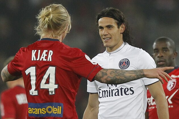 Lille's Simon Kjaer, left, and PSG's Edinson Cavani talk during their French League one soccer match at the Lille Metropole stadium, in Villeneuve d'Ascq, northern France, Wednesday, Dec. 3, 2014. (AP Photo/Michel Spingler)