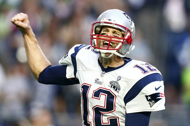 Feb 1, 2015; Glendale, AZ, USA; New England Patriots quarterback Tom Brady (12) celebrates after throwing a touchdown pass against the Seattle Seahawks in the second quarter in Super Bowl XLIX at University of Phoenix Stadium. Mandatory Credit: Mark J. Rebilas-USA TODAY Sports