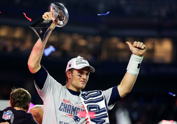 GLENDALE, AZ - FEBRUARY 01:  Tom Brady #12 of the New England Patriots celebrates with the Vince Lombardi Trophy after defeating the Seattle Seahawks 28-24 to win Super Bowl XLIX at University of Phoenix Stadium on February 1, 2015 in Glendale, Arizona.  (Photo by Elsa/Getty Images)