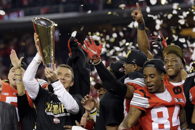 Ohio State head coach Urban Meyer celebrates with his team after the NCAA college football playoff championship game against Oregon Monday, Jan. 12, 2015, in Arlington, Texas. Ohio State won 42-20. (AP Photo/Eric Gay)