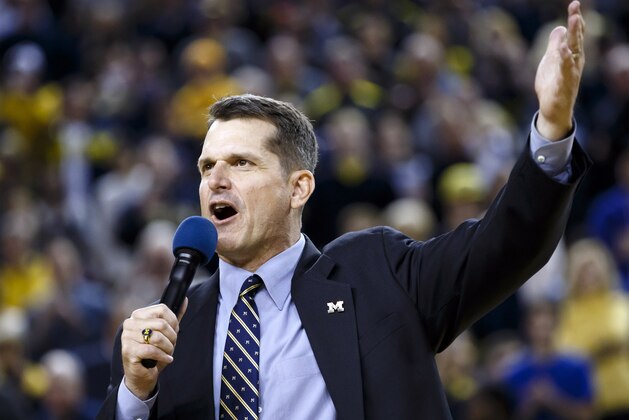 Dec 30, 2014; Ann Arbor, MI, USA; Michigan Wolverines head football coach Jim Harbaugh address the crowd during halftime of the game against the Illinois Fighting Illini at Crisler Center. Mandatory Credit: Rick Osentoski-USA TODAY Sports