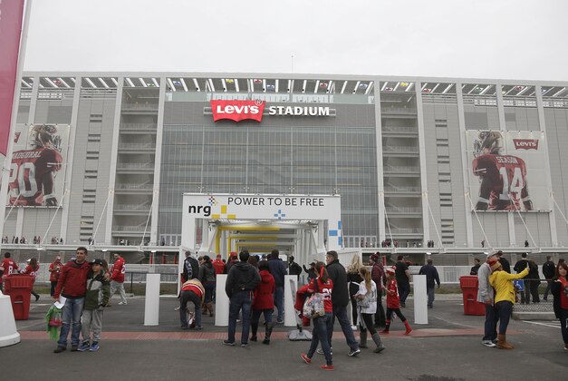Fans walk outside of Levi's Stadium before an NFL football game between the San Francisco 49ers and the San Diego Chargers in Santa Clara, Calif., Saturday, Dec. 20, 2014. (AP Photo/Marcio Jose Sanchez)