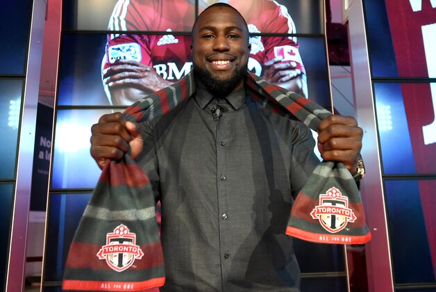 Jan 16, 2015; Toronto, ON, Canada; Toronto FC striker Jozy Altidore poses with a Toronto FC scarf at Air Canada Centre. Mandatory Credit: Dan Hamilton-USA TODAY Sports