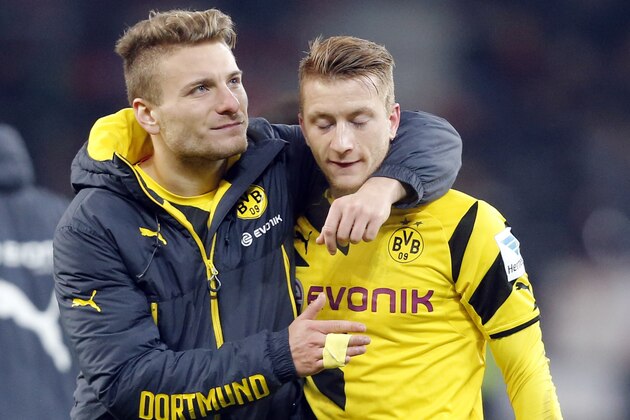 Dortmund's Ciro Immobile, left, hugs Dortmund's Marco Reus after the German first division Bundesliga soccer match between Bayer 04 Leverkusen and BvB Borussia Dortmund in Leverkusen, Germany, Saturday, Jan. 31, 2015. (AP Photo/Frank Augstein)