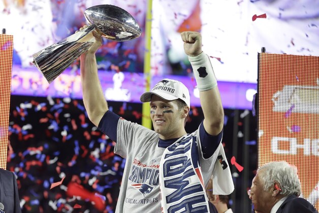 New England Patriots quarterback Tom Brady celebrates with the Vince Lombardi Trophy after the NFL Super Bowl XLIX football game against the Seattle Seahawks Sunday, Feb. 1, 2015, in Glendale, Ariz.  The Patriots won 28-24. (AP Photo/Michael Conroy)