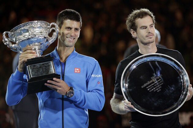 Novak Djokovic of Serbia, left,  holds the trophy with runner-up Andy Murray of Britain during the trophy presentation after winning the men's singles final at the Australian Open tennis championship in Melbourne, Australia, Sunday, Feb. 1, 2015. (AP Photo/Bernat Armangue)