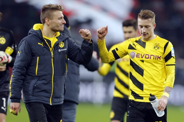 Dortmund's Ciro Immobile, left, and Dortmund's Marco Reus smile after the German first division Bundesliga soccer match between Bayer 04 Leverkusen and BvB Borussia Dortmund in Leverkusen, Germany, Saturday, Jan. 31, 2015. (AP Photo/Frank Augstein)