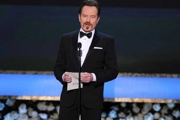 Bryan Cranston presents the award for outstanding female actor in a comedy series on stage at the 21st annual Screen Actors Guild Awards at the Shrine Auditorium on Sunday, Jan. 25, 2015, in Los Angeles. (Photo by Vince Bucci/Invision/AP)