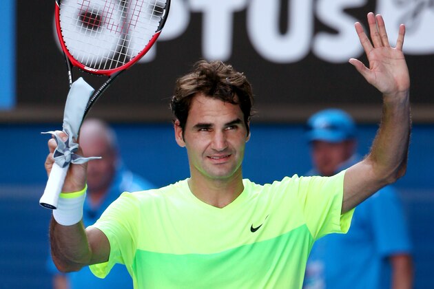 Roger Federer of Switzerland waves after defeating Simone Bolelli of Italy during their second round match at the Australian Open tennis championship in Melbourne, Australia, Wednesday, Jan. 21, 2015. (AP Photo/Rob Griffith)