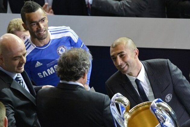 Chelsea coach Roberto Di Matteo, right, looks at UEFA president Michel Platini as he holds the trophy at the end of the Champions League final soccer match between Bayern Munich and Chelsea in Munich, Germany Saturday May 19, 2012. Chelsea's Didier Drogba scored the decisive penalty in the shootout as Chelsea beat Bayern Munich to win the Champions League final after a dramatic 1-1 draw on Saturday. (AP Photo/Kerstin Joensson)