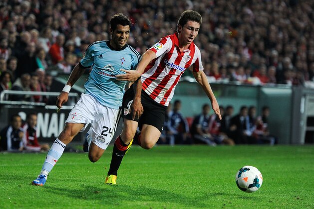 BILBAO, SPAIN - SEPTEMBER 16:  Augusto Fernandez (L) of RC Celta de Vigo duels for the ball with Aymeric Laporte of Athletic Club during the La Liga match between Athletic Club and RC Celta de Vigo at San Mames Stadium on September 16, 2013 in Bilbao, Spain.  (Photo by David Ramos/Getty Images)