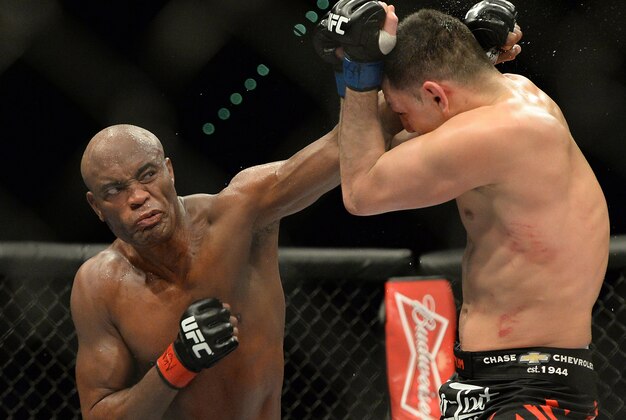 Jan 31, 2015; Las Vegas, NV, USA; Anderson Silva (red gloves) punches at Nick Diaz (blue gloves) during their middleweight bout during UFC 183 at the MGM Grand Garden Arena. Mandatory Credit: Jayne Kamin-Oncea-USA TODAY Sports