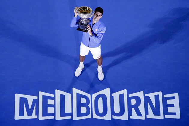 Novak Djokovic of Serbia poses with the trophy after defeating Andy Murray of Britain in the men's singles final at the Australian Open tennis championship in Melbourne, Australia, Sunday, Feb. 1, 2015. (AP Photo/Lee Jin-man)