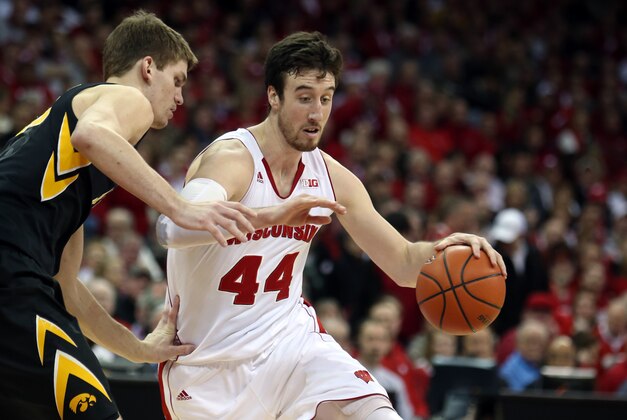 Jan 20, 2015; Madison, WI, USA; Wisconsin Badgers forward Frank Kaminsky (44) takes the ball around Iowa Hawkeyes center Adam Woodbury (34) at the Kohl Center. Wisconsin defeated Iowa 82-50. Mandatory Credit: Mary Langenfeld-USA TODAY Sports