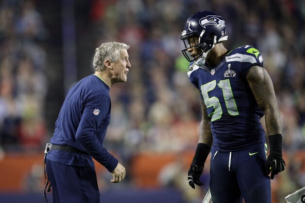 Seattle Seahawks head coach Pete Carroll cheers speaks to Bruce Irvin during the second half of NFL Super Bowl XLIX football game Sunday, Feb. 1, 2015, in Glendale, Ariz. (AP Photo/Matt Rourke)