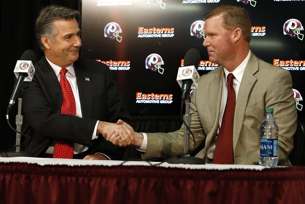 Jan 9, 2015; Ashburn, VA, USA; Washington Redskins president Bruce Allen (left) shakes hands with Washington Redskins new general manager Scot McCloughan (right) at McCloughan's introductory press conference at Redskins Park. Mandatory Credit: Geoff Burke-USA TODAY Sports