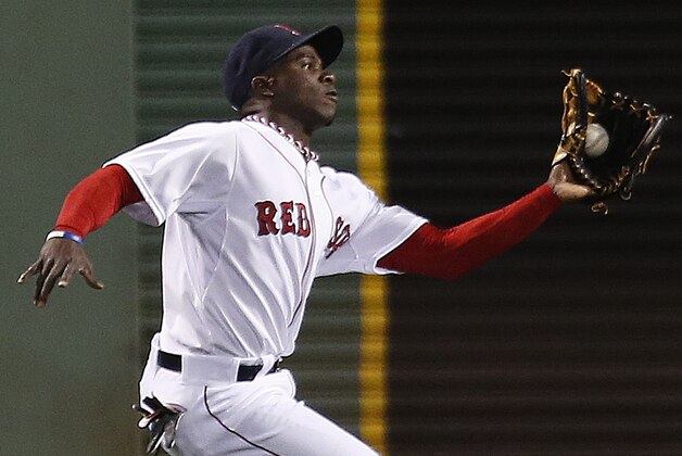 Boston Red Sox's Rusney Castillo catches the sacrifice fly by Tampa Bay Rays' Nick Franklin during the first inning of a baseball game in Boston, Wednesday, Sept. 24, 2014. (AP Photo/Michael Dwyer)