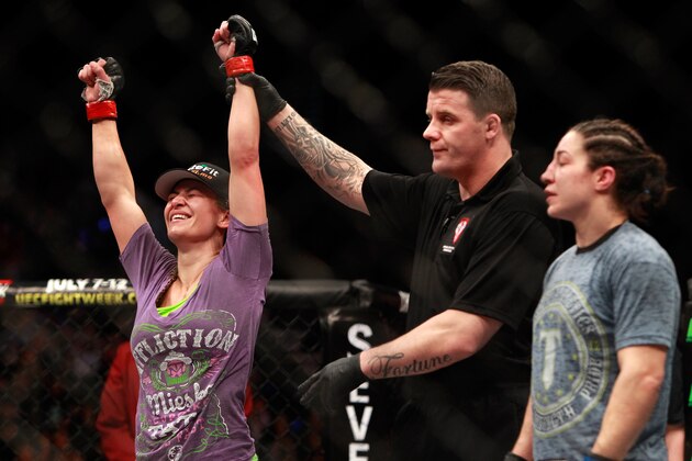 LAS VEGAS, NV - JANUARY 31:  Miesha Tate (L) is declared the winner over Sara McMann in their bantamweight bout during UFC 183 at the MGM Grand Garden Arena on January 31, 2015 in Las Vegas, Nevada. Tate won the fight by majority decision.  (Photo by Steve Marcus/Getty Images)