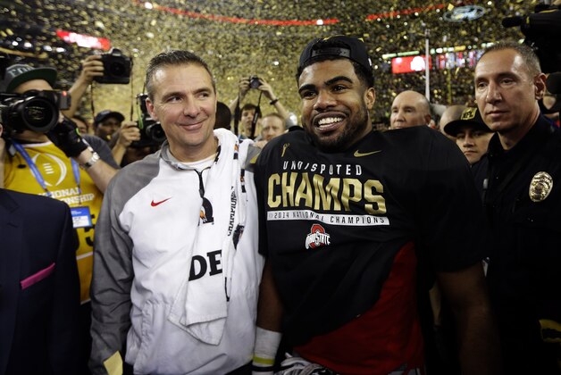 Ohio State head coach Urban Meyer and Ezekiel Elliott after the NCAA college football playoff championship game against Oregon Monday, Jan. 12, 2015, in Arlington, Texas. Ohio State won 42-20. (AP Photo/David J. Phillip)