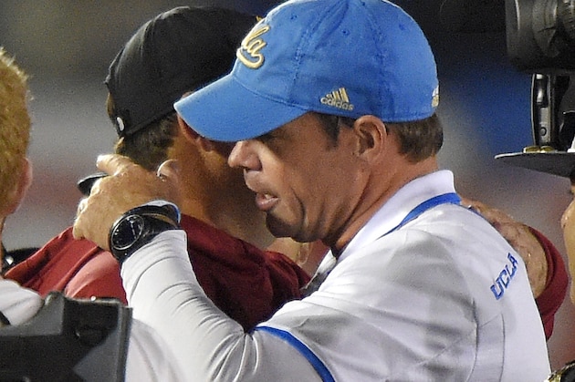 Southern California coach Steve Sarkisian, left, hugs UCLA coach Jim Mora after an NCAA college football game, Saturday, Nov. 22, 2014, in Pasadena, Calif. UCLA won 38-20. (AP Photo/Mark J. Terrill)