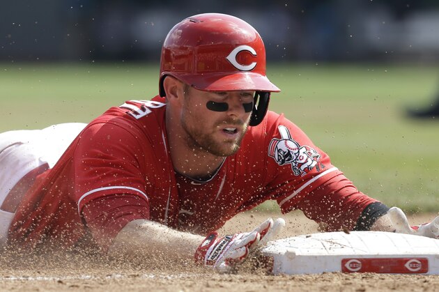 Cincinnati Reds' Zack Cozart slides into third base with a triple off Atlanta Braves relief pitcher David Hale in the eighth inning of a baseball game, Sunday, Aug. 24, 2014, in Cincinnati. The Reds won 5-3. (AP Photo/Al Behrman)