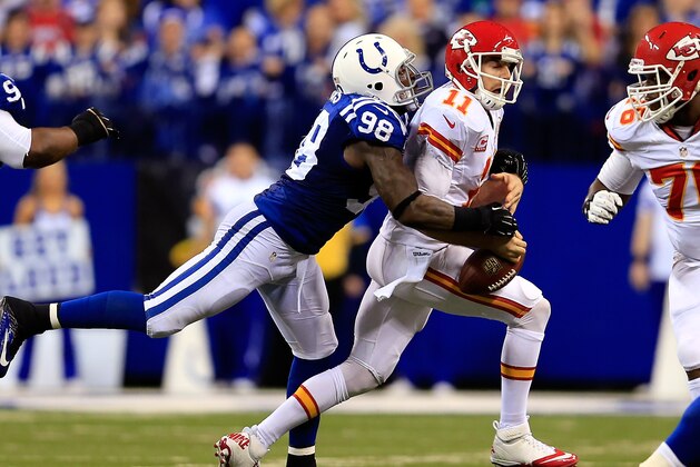 INDIANAPOLIS, IN - JANUARY 04:  Outside linebacker Robert Mathis #98 of the Indianapolis Colts forces a fumble by quarterback Alex Smith #11 of the Kansas City Chiefs during a Wild Card Playoff game at Lucas Oil Stadium on January 4, 2014 in Indianapolis, Indiana.  (Photo by Rob Carr/Getty Images)