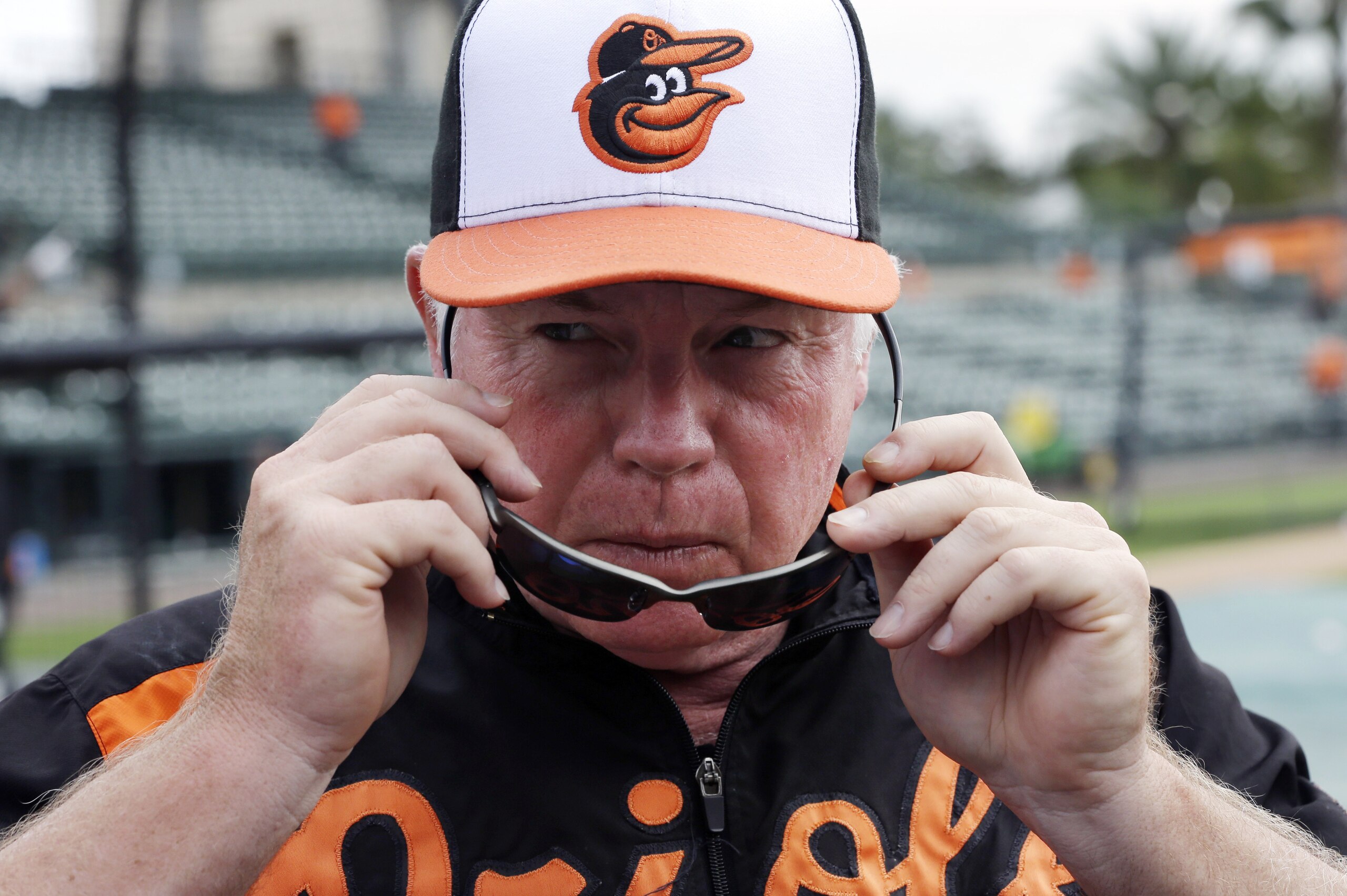 Baltimore Orioles manager Buck Showalter puts on his sunglasses during batting practice before a spring exhibition baseball game against the Pittsburgh Pirates in Sarasota, Fla., Sunday, March 23, 2014. (AP Photo/Carlos Osorio)