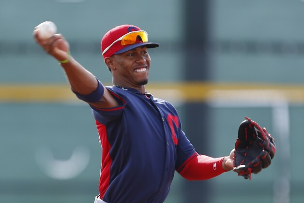 Cleveland Indians shortstop Francisco Lindor throws during spring training baseball practice in Goodyear, Ariz., Friday, Feb. 21, 2014. (AP Photo/Paul Sancya)