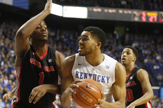 Feb 3, 2015; Lexington, KY, USA; Kentucky Wildcats forward Karl-Anthony Towns (12) takes the ball to the basket against Georgia Bulldogs center Yante Maten (1) in the first half at Rupp Arena. Mandatory Credit: Mark Zerof-USA TODAY Sports