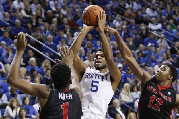 Kentucky's Andrew Harrison (5) shoots between Georgia's Yante Maten (1) and Kenny Gaines (12) during the second half of an NCAA college basketball game, Tuesday, Feb. 3, 2015, in Lexington, Ky. Kentucky won 69-58. (AP Photo/James Crisp)