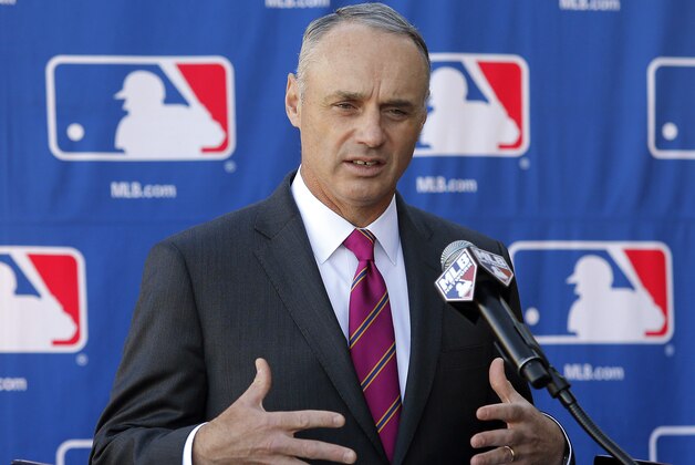 FILE - In a Jan. 15, 2015 file photo then Commissioner-elect Rob Manfred speaks during a news conference at the Major League Baseball owners meeting in Phoenix.   Monday morning, Jan. 26, 2015, was the first business day after Manfred succeeded Bud Selig and started a five-year term as commissioner. (AP Photo/Rick Scuteri, file)