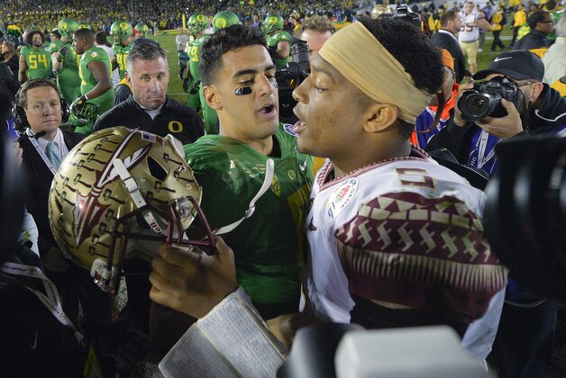 Oregon quarterback Marcus Mariota, center left, greets Florida State quarterback Jameis Winston after Oregon's win in the Rose Bowl NCAA college football playoff semifinal, Thursday, Jan. 1, 2015, in Pasadena, Calif. (AP Photo/Mark J. Terrill)