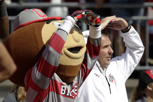 Ohio State head coach Urban Meyer, right, sings
