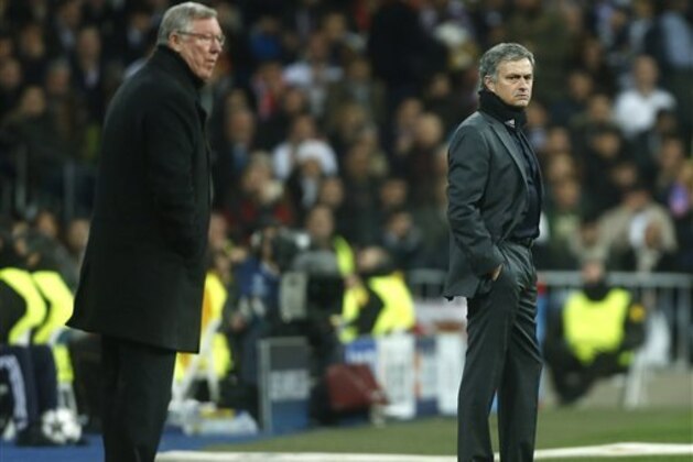 Manchester United's manager Sir Alex Ferguson, left, and Real Madrid's coach Jose Mourinho stand on the touchline during the Champions League round of 16 first leg soccer match between Real Madrid and Manchester United at the Santiago Bernabeu stadium in Madrid, Wednesday Feb. 13, 2013. (AP Photo/Andres Kudacki)
