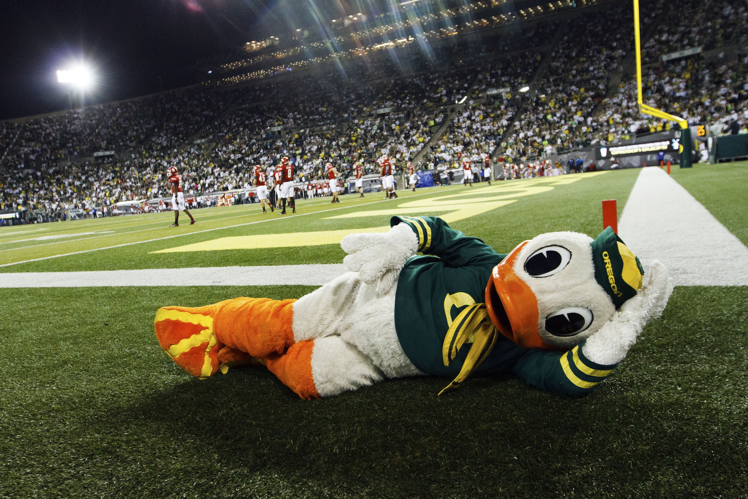 FILE - In this Aug. 30, 2014, file photo, the Oregon Duck lies on the ground during the fourth quarter of an NCAA college football game in Eugene, Ore. Ahead of the 2014 college football season, The Associated Press asked its panel of Top 25 voters, who are known for ranking the nation's top teams each week, to weigh in on which school had the best mascot. Oregon’s costumed Duck came in fifth place. (AP Photo/Ryan Kang, File)