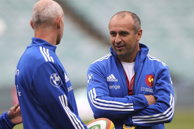 France's coach Philippe Saint-Andre, right, speaks with trainers during the captains run in Sydney, Australia, Friday, June 20, 2014. France will play against Australia in the third test in Sydney, on Saturday. (AP Photo/Rob Griffith)