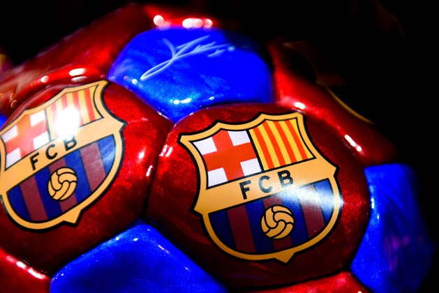 BARCELONA, SPAIN - OCTOBER 21:  A FC Barcelona souvenir ball is seen in a souvenir stall outside the stadium prior to a UEFA Champions League Group F match between FC Barcelona and AFC Ajax at the Camp Nou Stadium on October 21, 2014 in Barcelona, Spain.  (Photo by David Ramos/Getty Images)