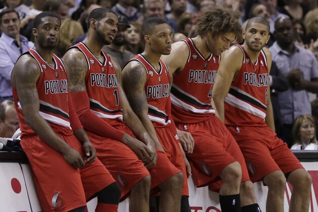 Portland Trail Blazers starters, from left, Wesley Matthews, LaMarcus Aldridge, Damian Lillard, Robin Lopez, and Nicolas Batum, sit on the scorers table during a timeout in the second half of Game 5 of a Western Conference semifinal NBA basketball playoff series against the San Antonio Spurs, Wednesday, May 14, 2014, in San Antonio. San Antonio won 104-82. (AP Photo/Eric Gay)