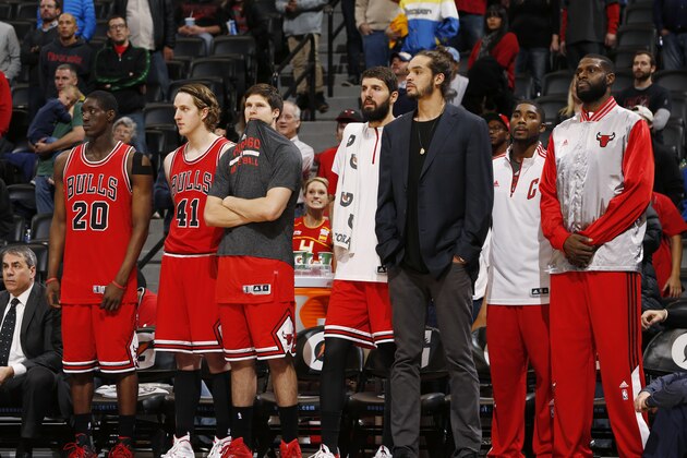 From left, Chicago Bulls forwards Tony Snell, Cameron Bairstow, of Australia, Doug McDermott, Nikola Mirotic, of Serbia, Joakim Noah, guard E'Twaun Moore and center Nazr Mohammed look on as time runs down in the fourth quarter of the Denver Nuggets' 114-109 victory over the Bulls in an NBA basketball game in Denver on Tuesday, Nov. 25, 2014. (AP Photo/David Zalubowski)