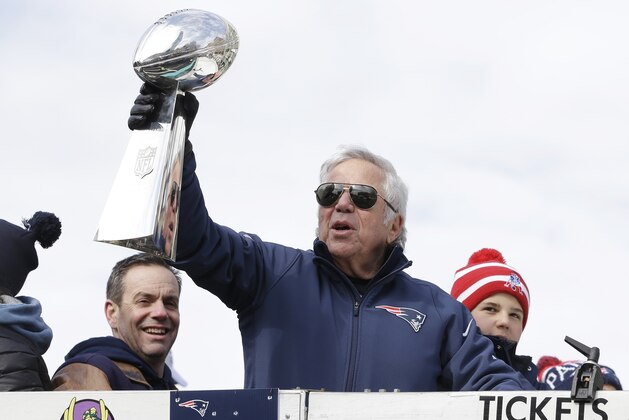 New England Patriots owner Robert Kraft shows the Vince Lombardi Trophy to the crowd as he passes by during a parade in Boston Wednesday, Feb. 4, 2015, to honor the Patriots' victory over the Seattle Seahawks in Super Bowl XLIX Sunday in Glendale, Ariz. (AP Photo/Steven Senne)