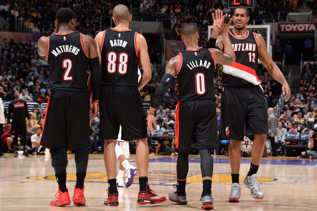 LOS ANGELES, CA - JANUARY 11:  LaMarcus Aldridge #12, Damian Lillard #0 of the Portland Trail Blazers and their teammates celebrate during the game against the Los Angeles Lakers on January 11, 2015 at STAPLES Center in Los Angeles, California. NOTE TO USER: User expressly acknowledges and agrees that, by downloading and/or using this Photograph, user is consenting to the terms and conditions of the Getty Images License Agreement. Mandatory Copyright Notice: Copyright 2015 NBAE (Photo by Andrew D. Bernstein/NBAE via Getty Images)