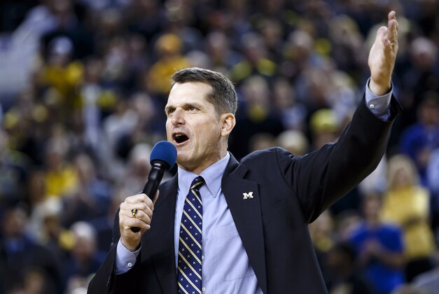 Dec 30, 2014; Ann Arbor, MI, USA; Michigan Wolverines head football coach Jim Harbaugh address the crowd during halftime of the game against the Illinois Fighting Illini at Crisler Center. Mandatory Credit: Rick Osentoski-USA TODAY Sports