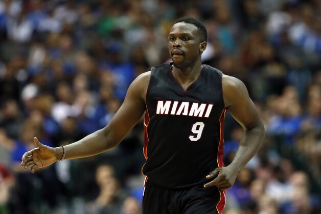 Miami Heat's Luol Deng (9) of Britain jogs up court during an NBA basketball game  against the Dallas Mavericks, Sunday, Nov. 9, 2014, in Dallas. (AP Photo/Tony Gutierrez)