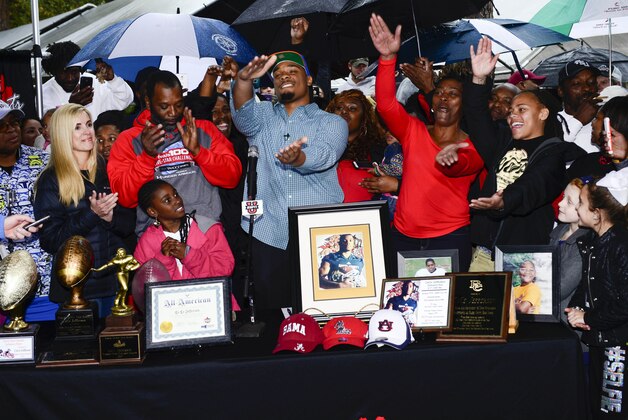 Feb 4, 2015; Glen Saint Mary, FL, USA; Ce Ce Jefferson signs with the University of Florida at his home near  Baker County High School  as his parents Leo and Annette Jefferson look on. Mandatory Credit: Richard Dole-USA TODAY Sports